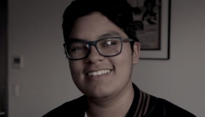 A desaturated portrait of a Ghetto Film School student in an empty classroom.